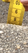 Image of one side of a tape measure being used to measure the height of a step.