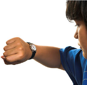 Image of a boy checking his watch.